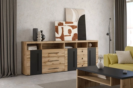 Komoda z szufladami Roger 133 cm dąb wotan / czarny gustowna stylistyka komody wzbogacona o stylowe czarne dodatki idealna do salonu sypialni