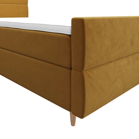 Łóżko kontynentalne Benet 120x200 musztardowe w nowoczesnym skandynawskim stylu z tapicerowanym zagłówkiem oraz zanóżkiem łóżko z pojemnikiem