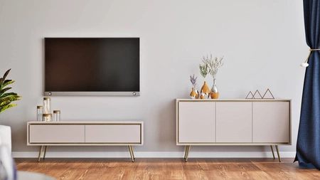Meblościanka Nevea beżowa eleganckie meble do salonu o subtelnej kolorystyce bezuchwytowe bryły wzbogacone designerskim obrzeżem